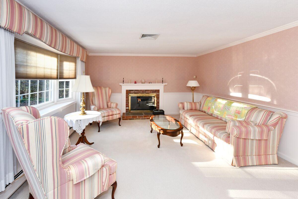 254 Cedric Road Centerville, MA 02632 - Photo 10 of 24 a living room with furniture a fireplace and a large window