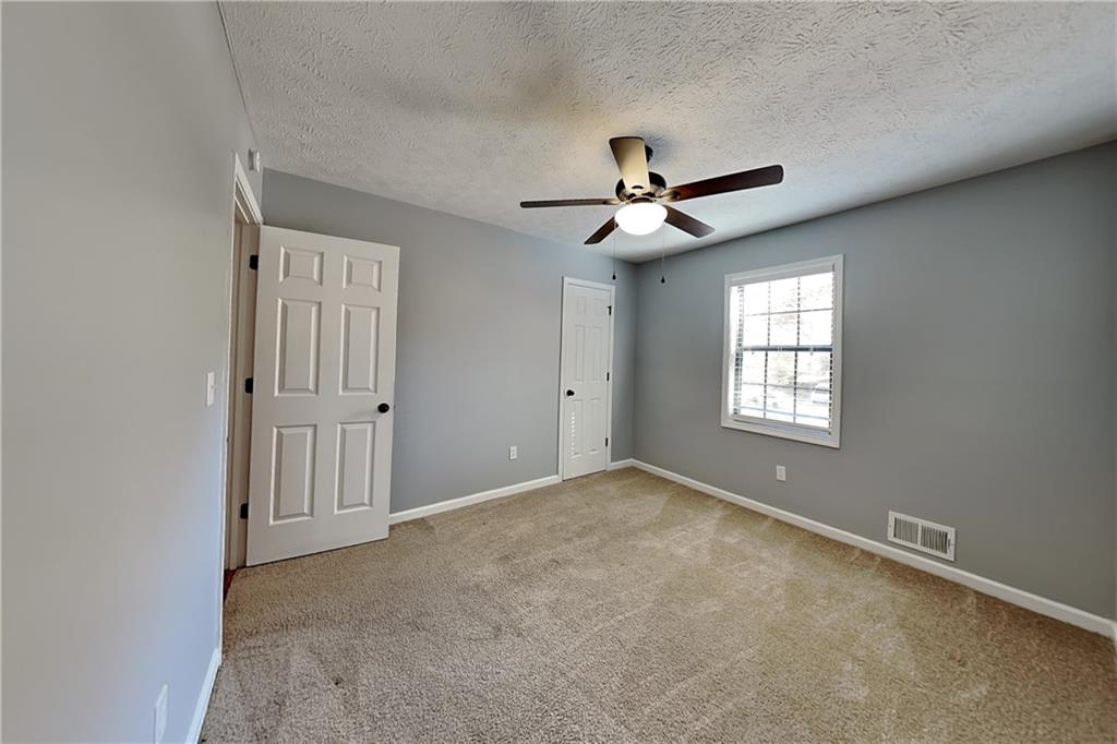 4304 Falcon Crest Drive Flowery Branch, GA 30542 - Photo 12 of 21 a view of an empty room with a window