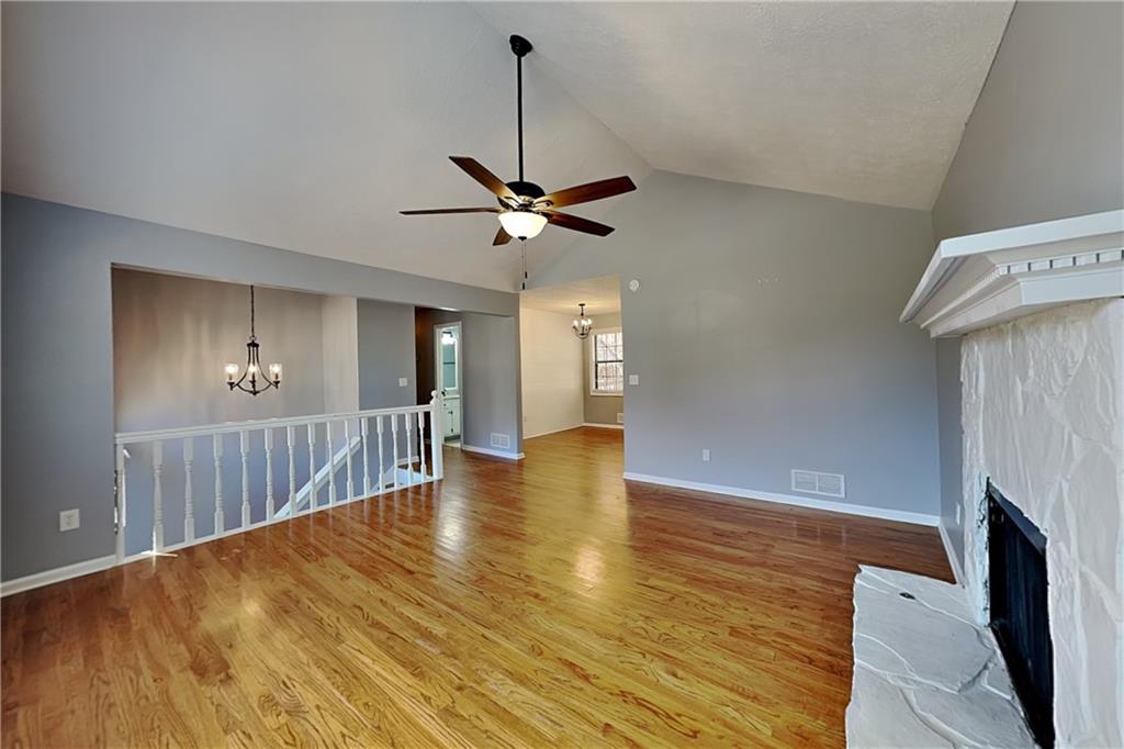 4304 Falcon Crest Drive Flowery Branch, GA 30542 - Photo 2 of 21 a view of room with wooden floor a ceiling fan and a window