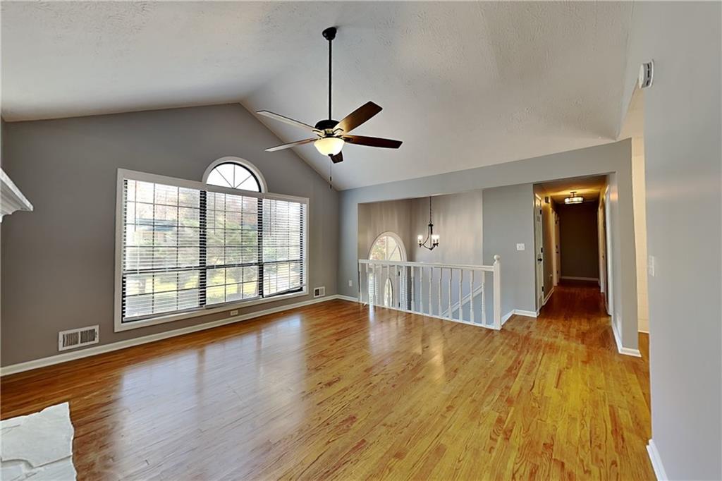 4304 Falcon Crest Drive Flowery Branch, GA 30542 - Photo 3 of 21 a view of empty room with wooden floor and fan