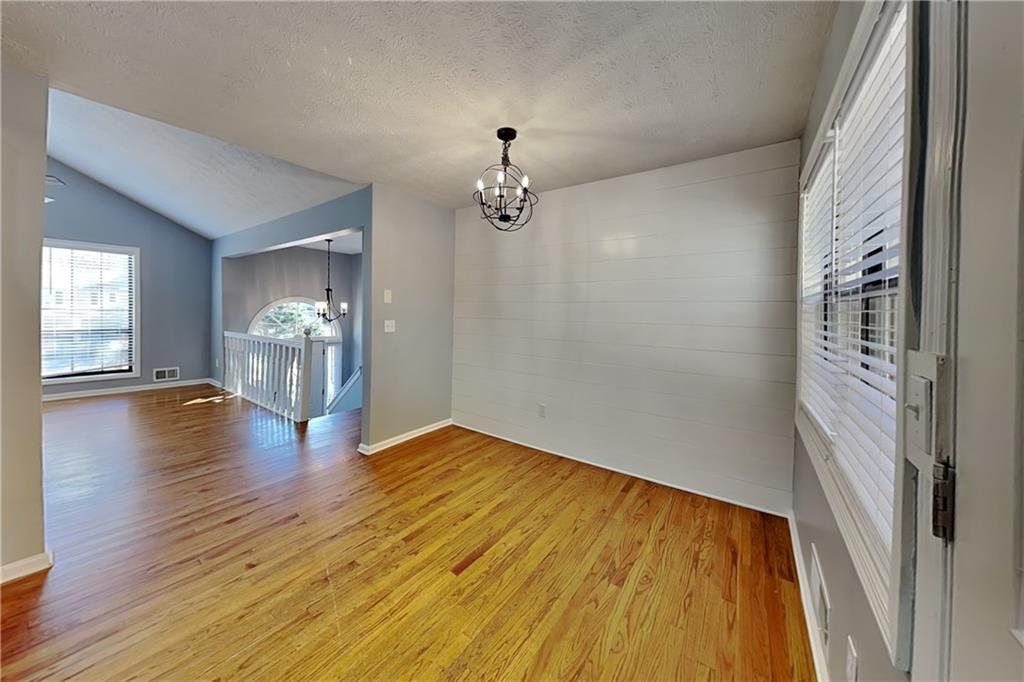 4304 Falcon Crest Drive Flowery Branch, GA 30542 - Photo 5 of 21 wooden floor in an empty room with a window