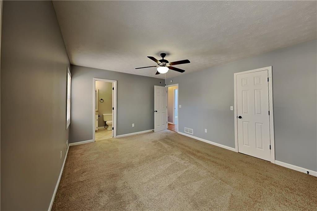 4304 Falcon Crest Drive Flowery Branch, GA 30542 - Photo 7 of 21 a view of an empty room with a ceiling fan