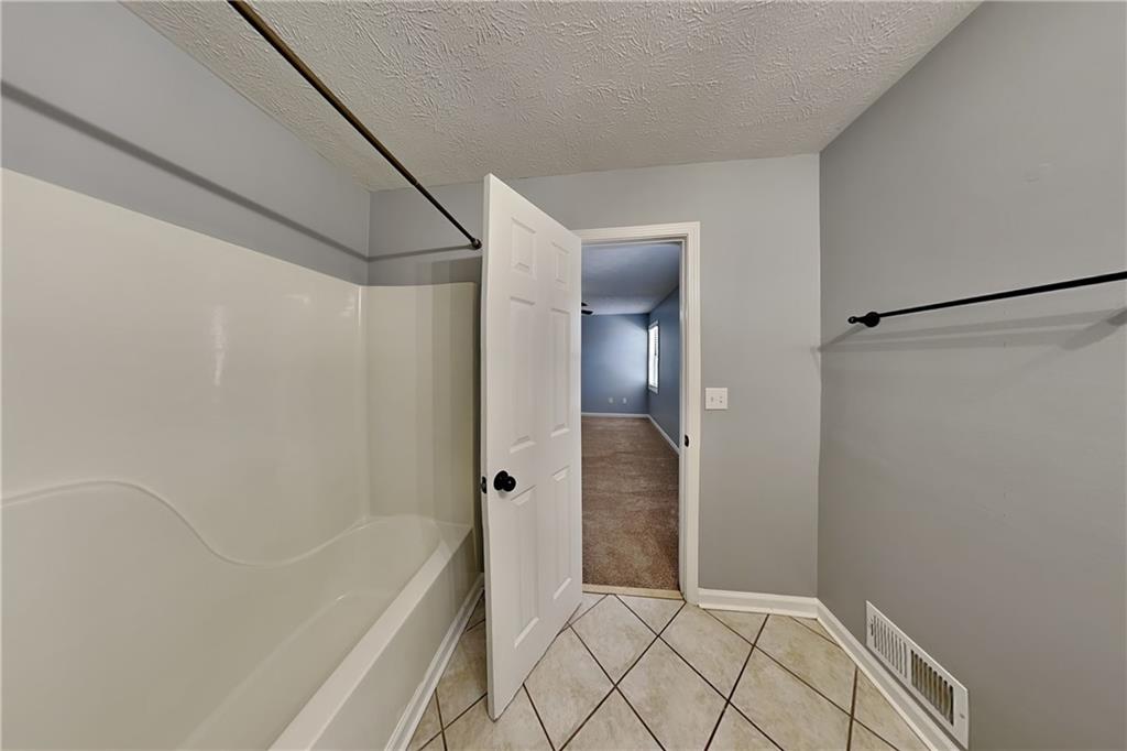 4304 Falcon Crest Drive Flowery Branch, GA 30542 - Photo 9 of 21 a bathroom with a bathtub and a shower