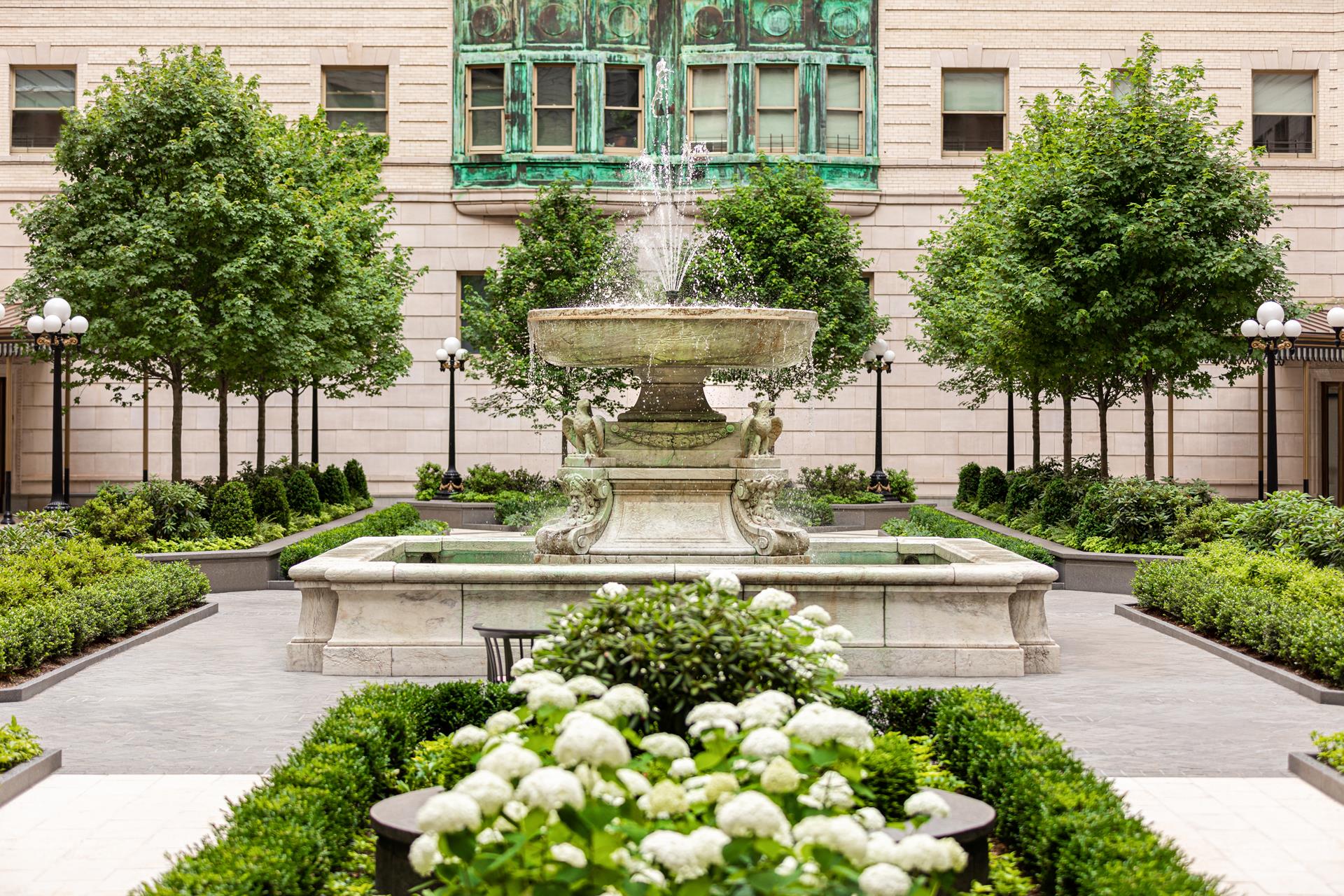 225 West 86th Street, Unit 407 Manhattan, NY 10024 - Photo 19 of 20 a view of a white house with a yard and potted plants