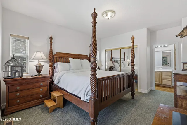 a bedroom with a bed and a table