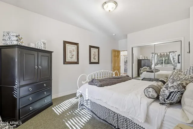 a bed room with a bed and a mirror