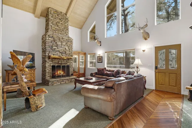a living room with furniture a fireplace and a chandelier