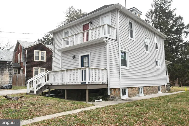 a view of a white house with large windows