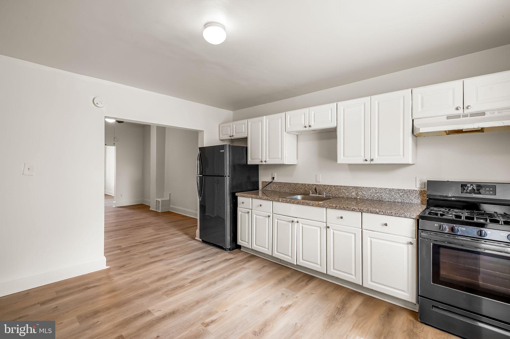 3021 Belair Road Baltimore, MD 21213 - Photo 11 of 27 a kitchen with stainless steel appliances granite countertop a stove and a refrigerator