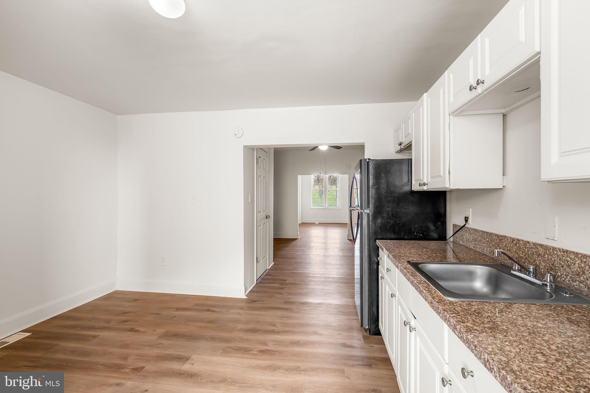3021 Belair Road Baltimore, MD 21213 - Photo 12 of 27 a kitchen with stainless steel appliances granite countertop a sink stove and refrigerator