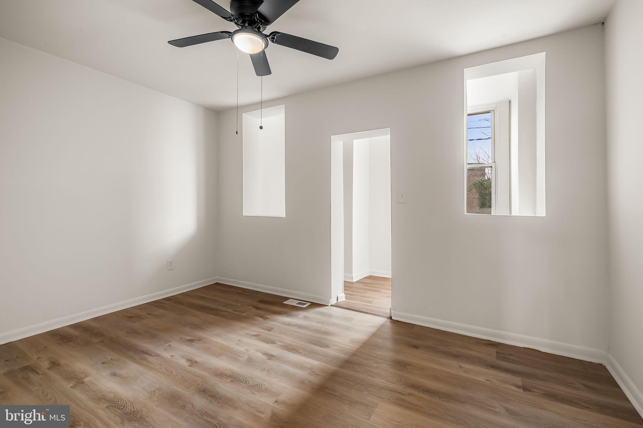 3021 Belair Road Baltimore, MD 21213 - Photo 15 of 27 a view of an empty room with wooden floor and a window