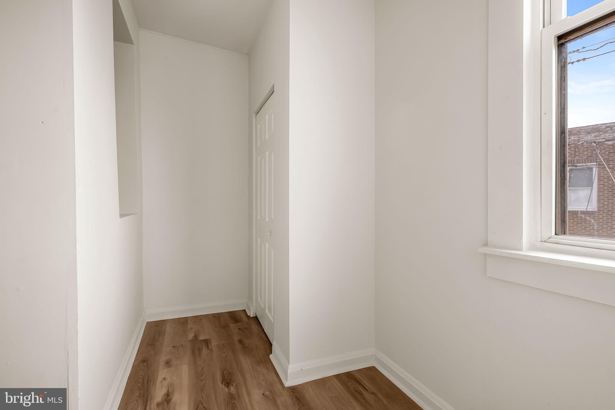 3021 Belair Road Baltimore, MD 21213 - Photo 17 of 27 a view of a small space with wooden floor and a window