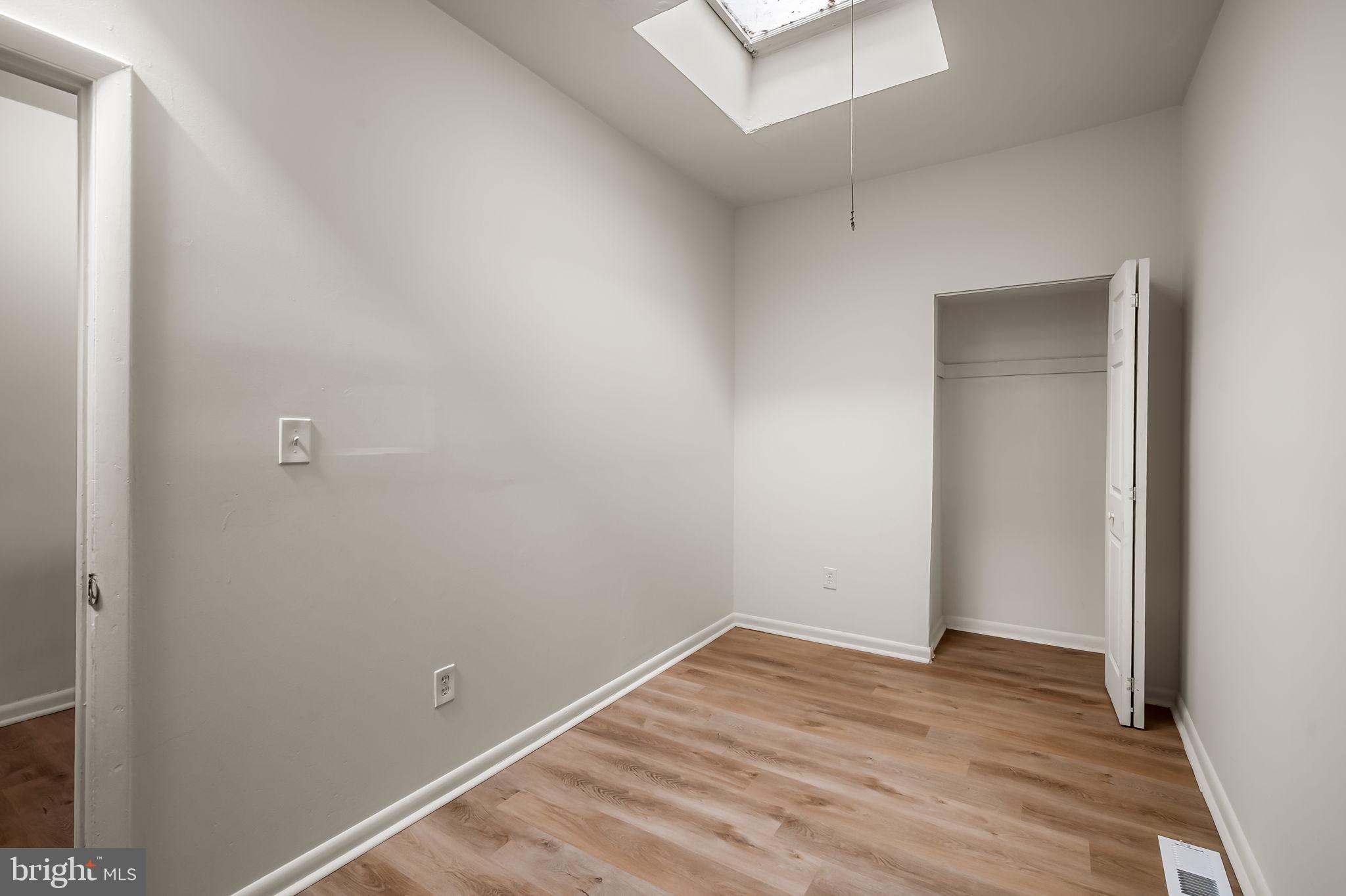 3021 Belair Road Baltimore, MD 21213 - Photo 20 of 27 an empty room with wooden floor and closet
