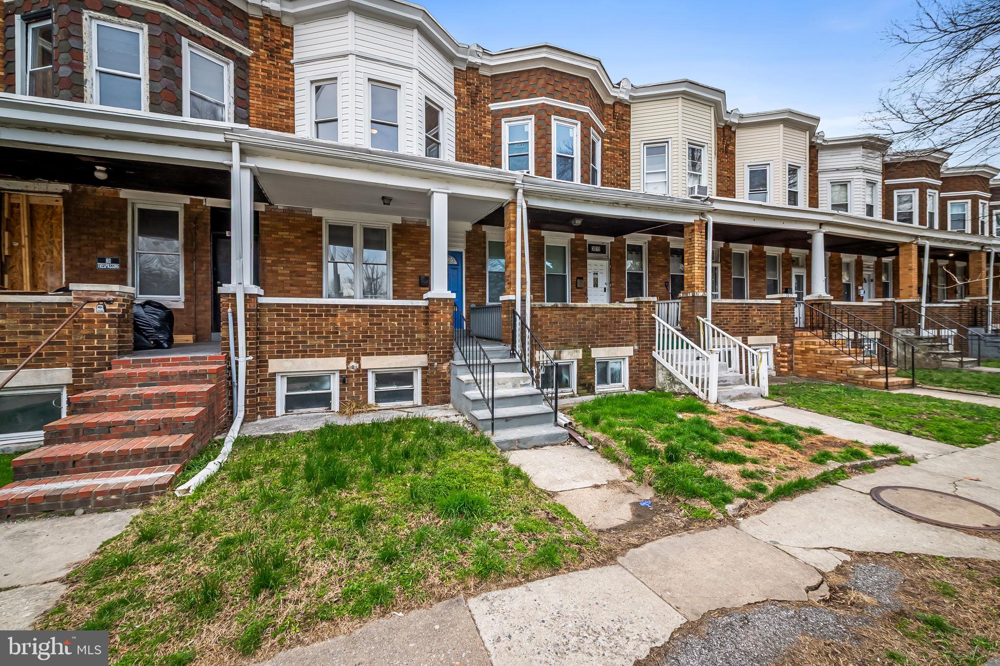 3021 Belair Road Baltimore, MD 21213 - Photo 2 of 27 front view of a brick house with a yard