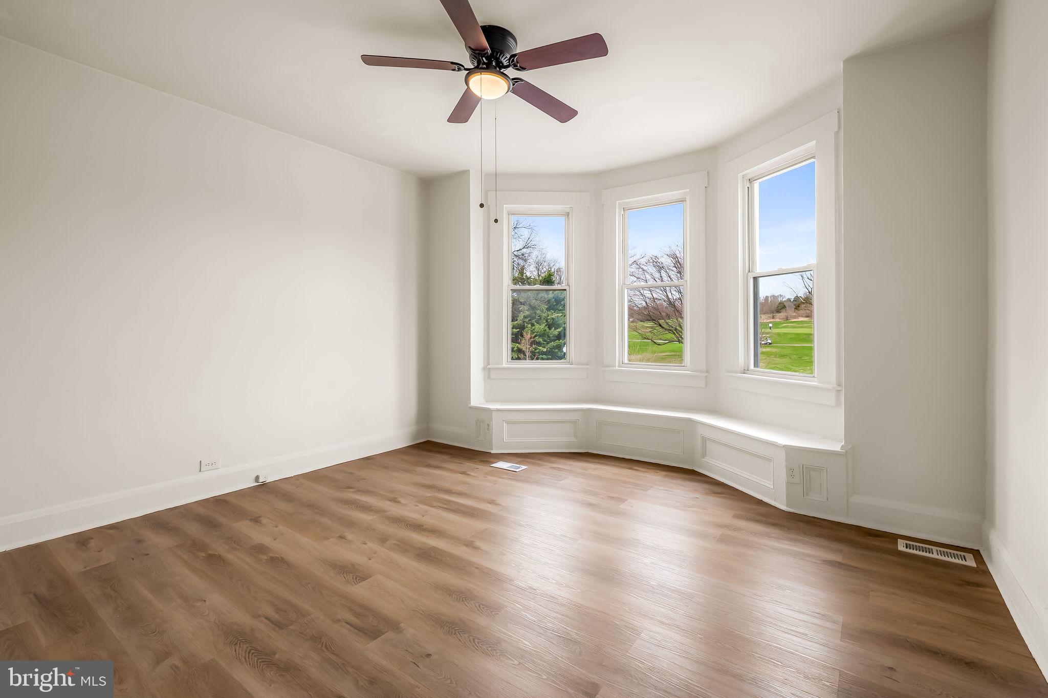 3021 Belair Road Baltimore, MD 21213 - Photo 22 of 27 a view of empty room with wooden floor and fan