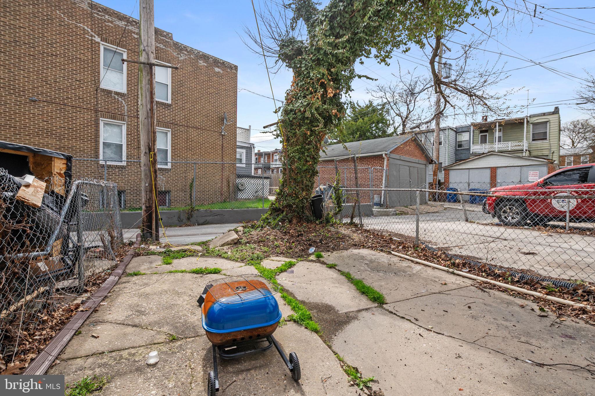 3021 Belair Road Baltimore, MD 21213 - Photo 26 of 27 a view of a white house with a yard and sitting area