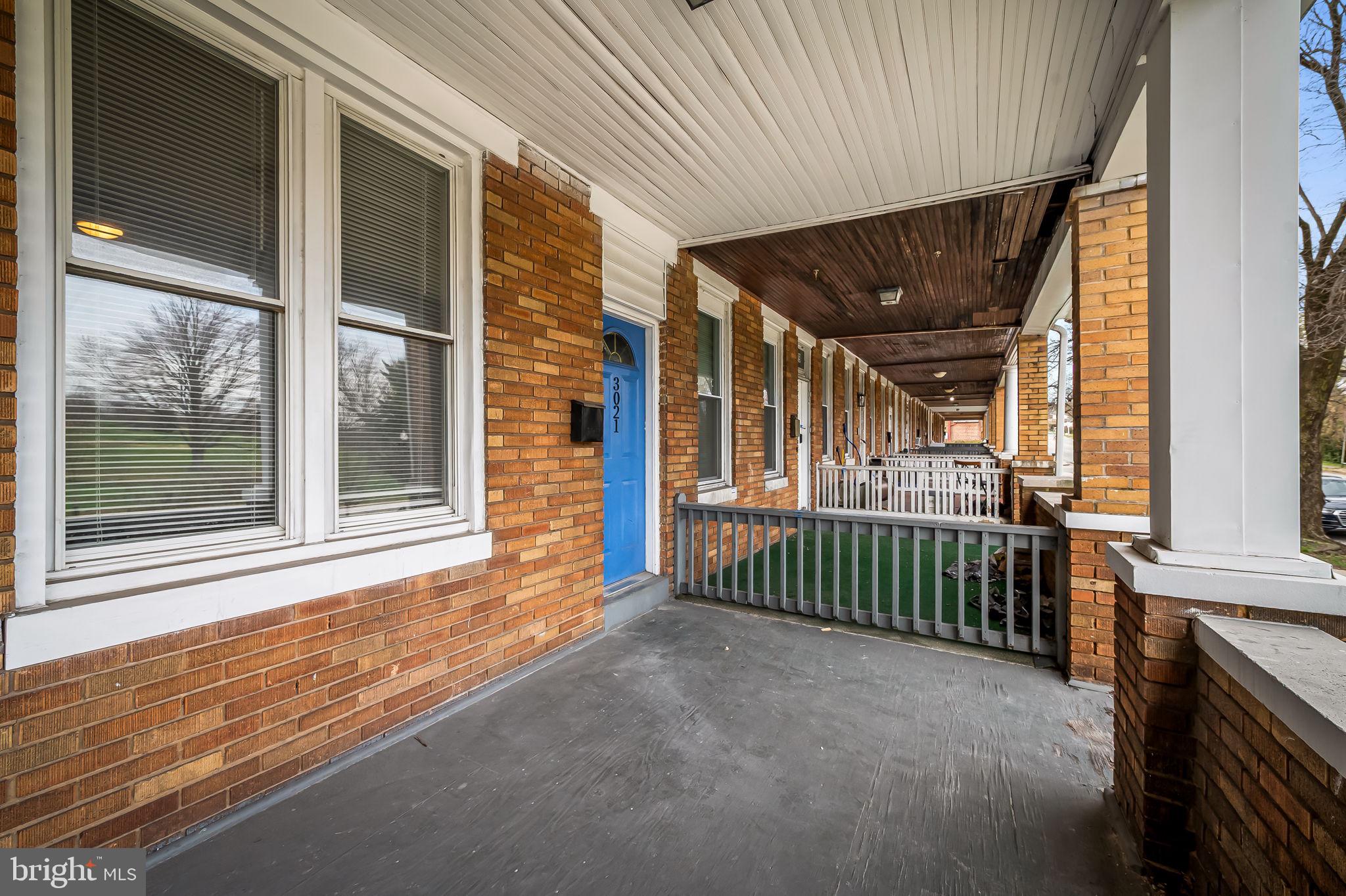 3021 Belair Road Baltimore, MD 21213 - Photo 3 of 27 a view of a porch with a table and chairs