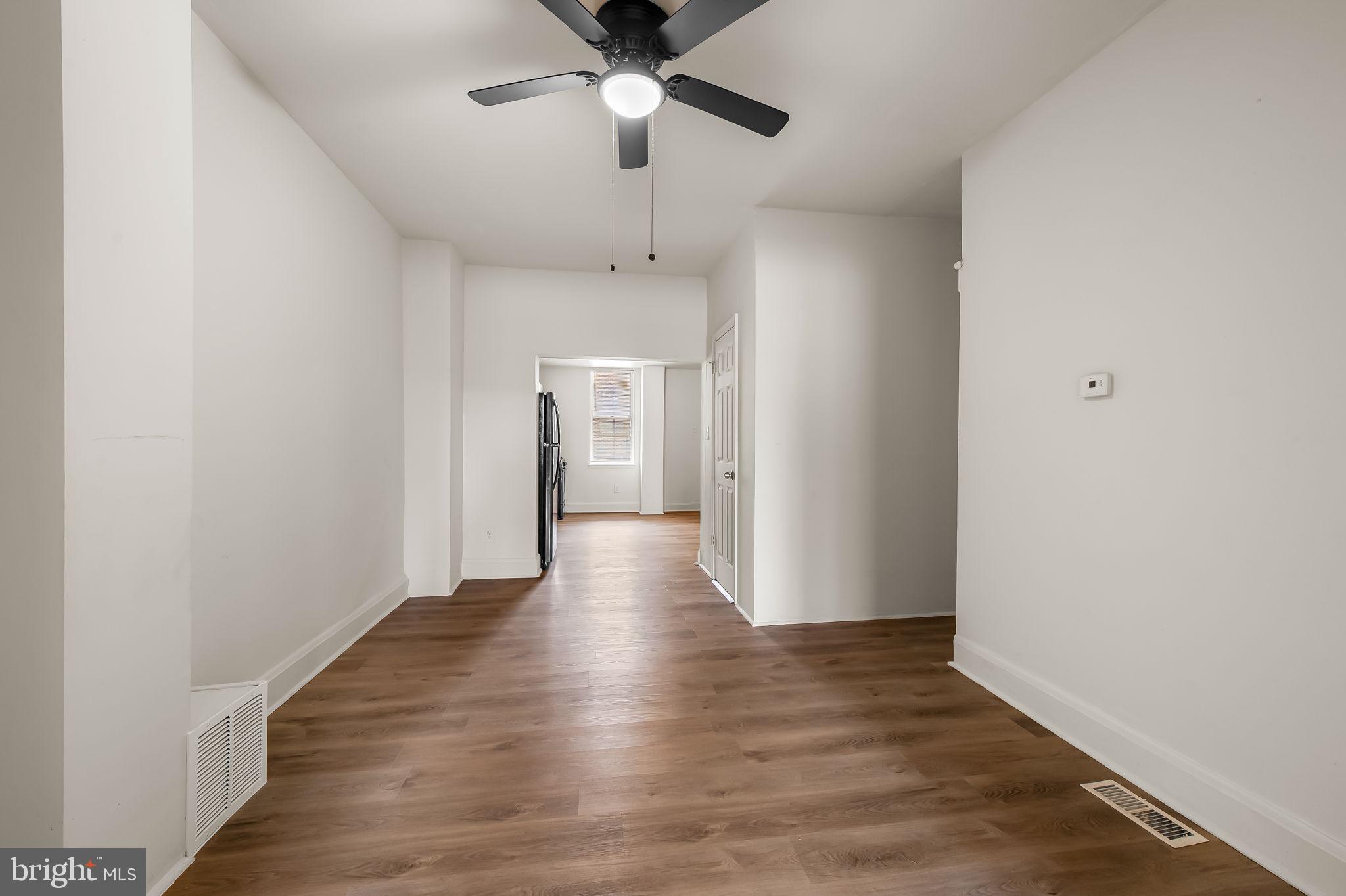 3021 Belair Road Baltimore, MD 21213 - Photo 8 of 27 a view of an empty room with wooden floor