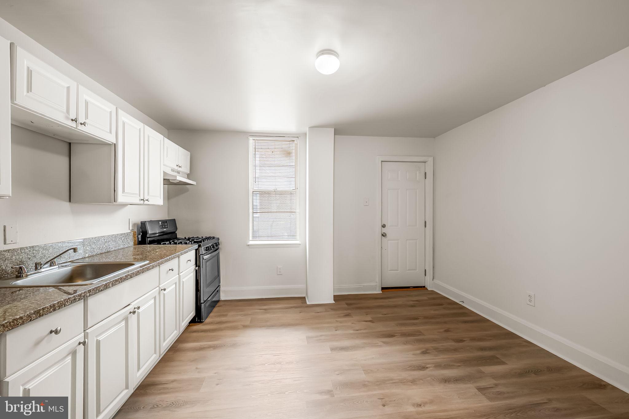 3021 Belair Road Baltimore, MD 21213 - Photo 9 of 27 a kitchen with a sink stove and cabinets