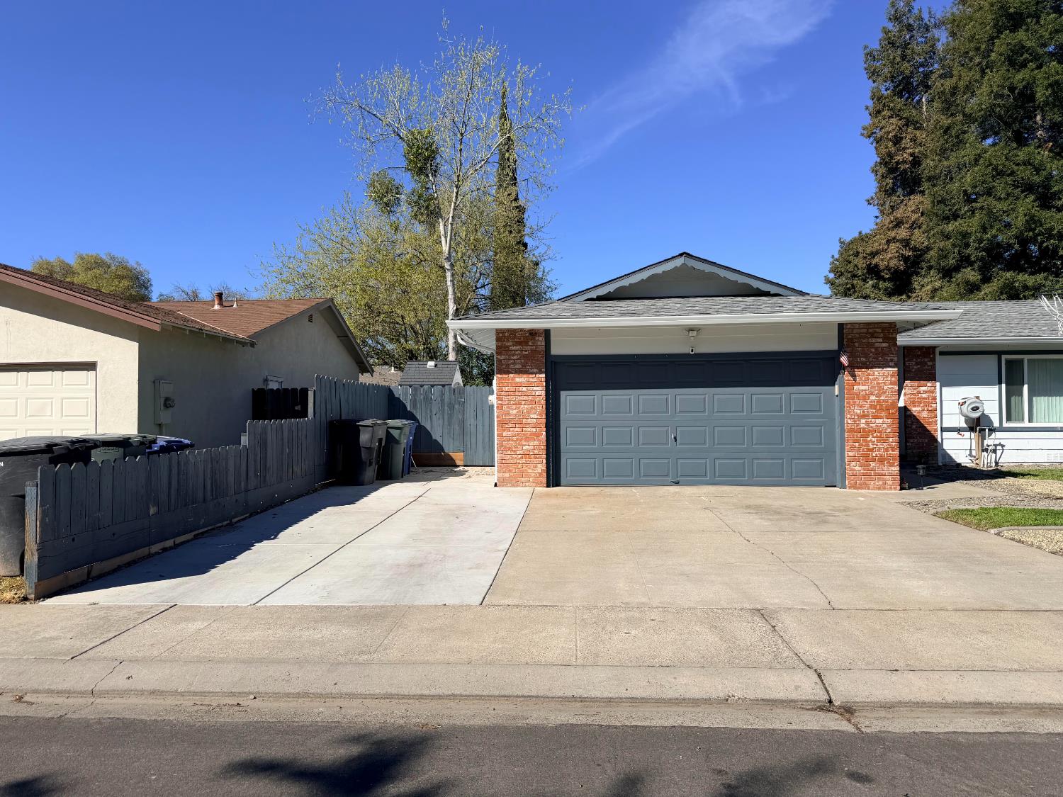 1909 Devin Drive Modesto, CA 95355 - Photo 1 of 21 a front view of a house with a yard and garage