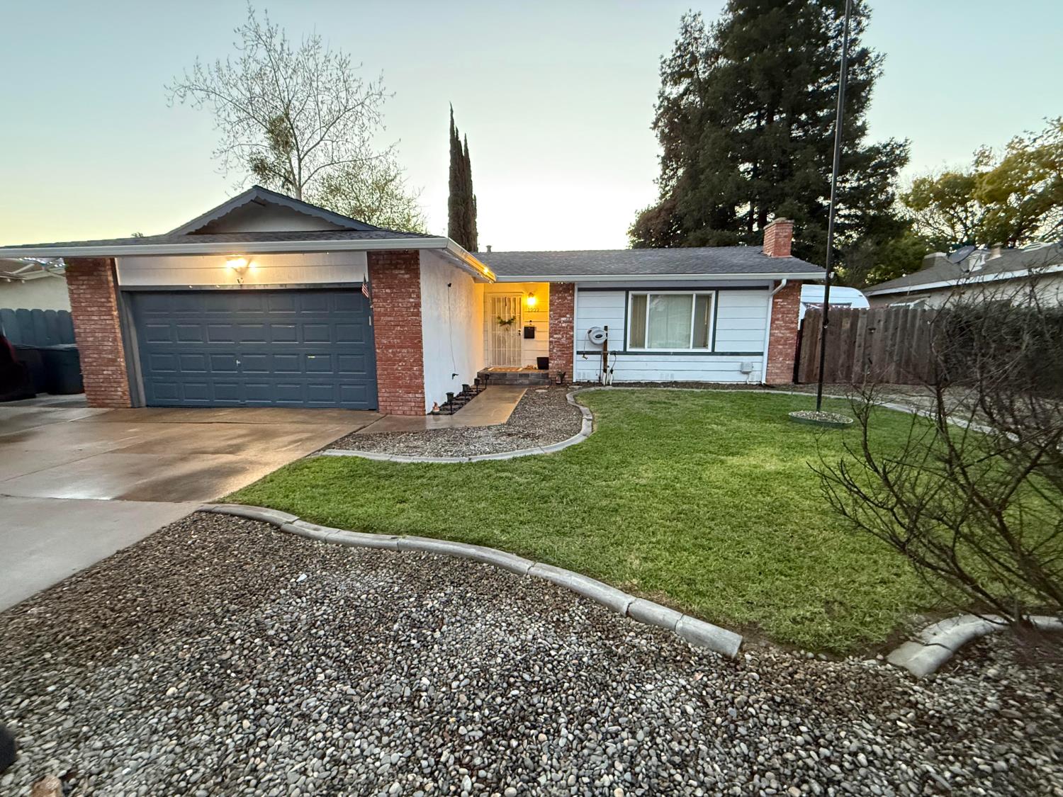 1909 Devin Drive Modesto, CA 95355 - Photo 4 of 21 a front view of a house with a yard and garage