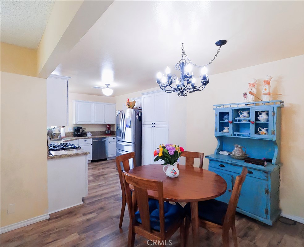 4757 Dundee Road Riverside, CA 92503 - Photo 13 of 26 a view of a dining room with furniture and chandelier