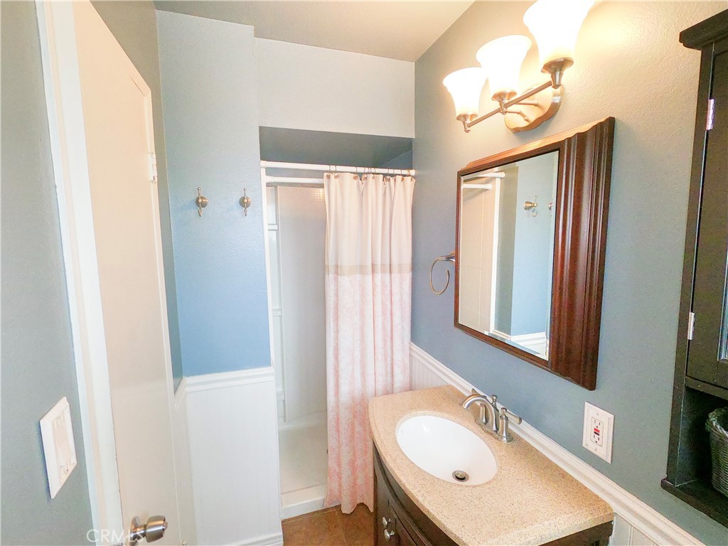 4757 Dundee Road Riverside, CA 92503 - Photo 16 of 26 a bathroom with a sink a mirror and a shower