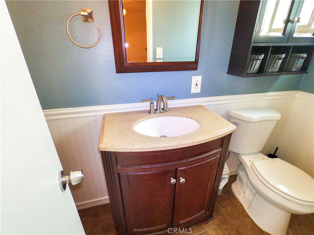 4757 Dundee Road Riverside, CA 92503 - Photo 17 of 26 a bathroom with a toilet a sink and a mirror