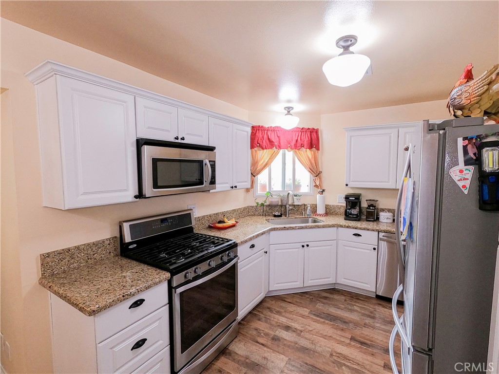 4757 Dundee Road Riverside, CA 92503 - Photo 8 of 26 a kitchen with stainless steel appliances a stove microwave and refrigerator
