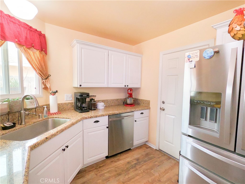 4757 Dundee Road Riverside, CA 92503 - Photo 9 of 26 a kitchen with a sink stove and refrigerator