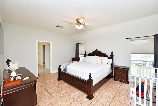 a spacious bedroom with a bed and a book shelf