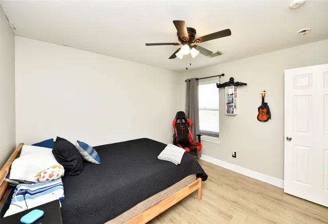 a view of a workspace with furniture and a ceiling fan