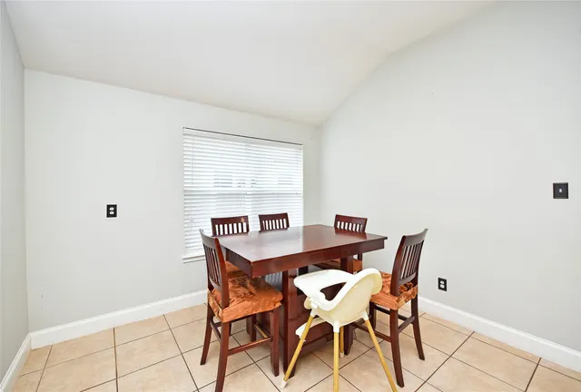 a view of a dining room with furniture and window