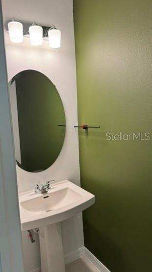 4520 Ranunculus Street Haines City, FL 33844 - Photo 17 of 19 a bathroom with a sink and mirror