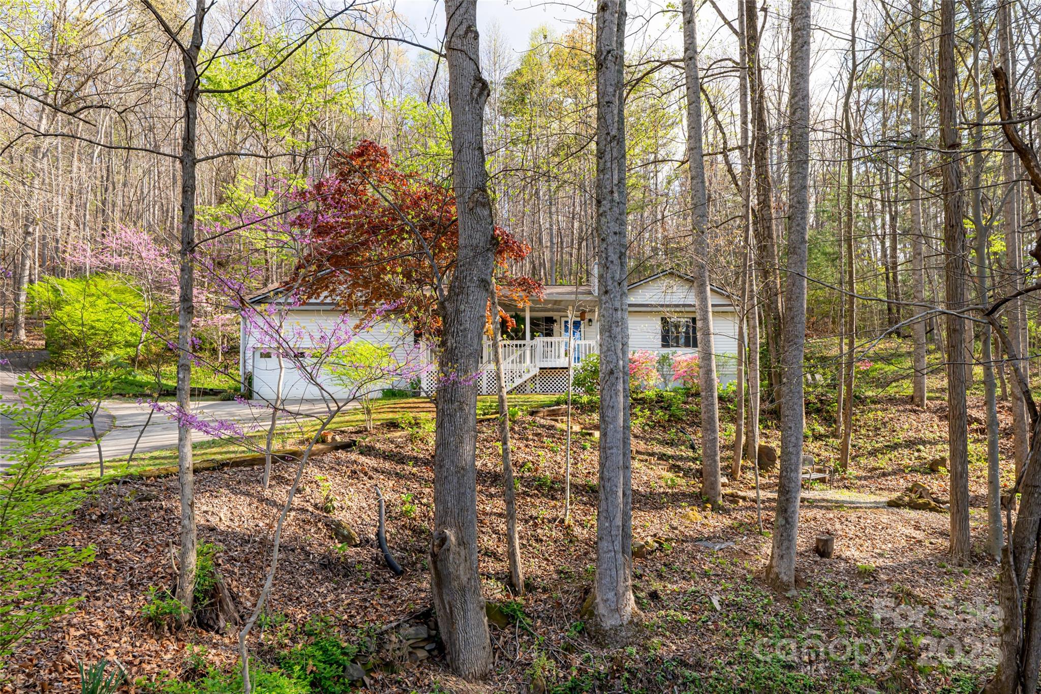 a view of a brick house with a yard and sitting area
