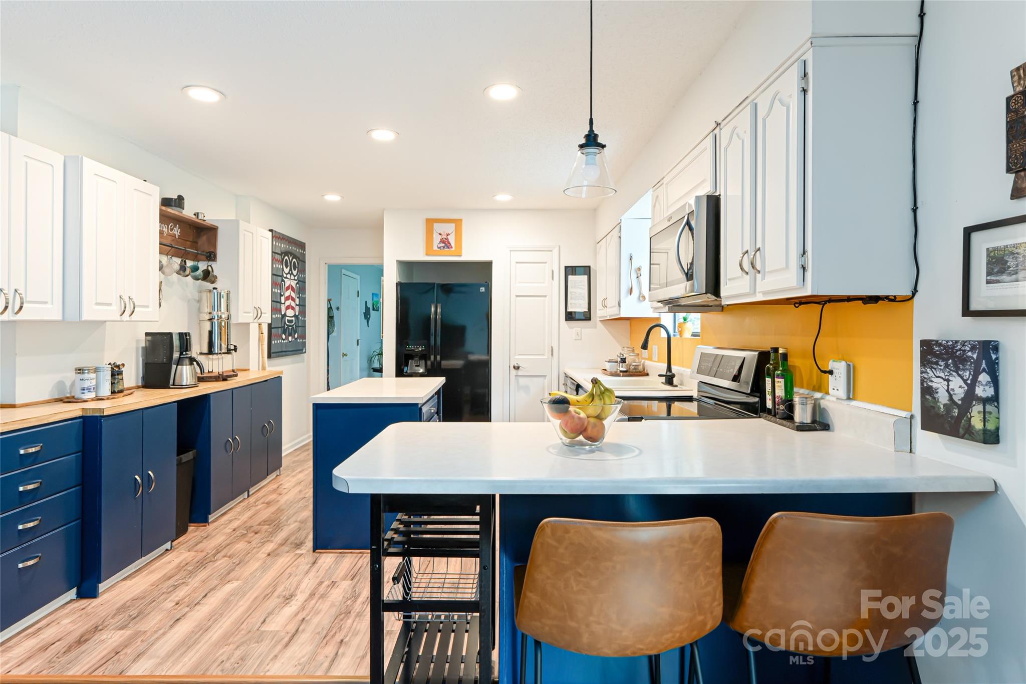 21 Mann Road Asheville, NC 28805 - Photo 16 of 36 a kitchen with granite countertop a table chairs sink and cabinets