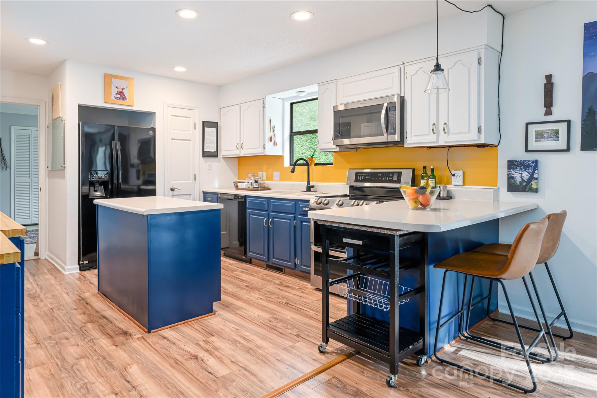 21 Mann Road Asheville, NC 28805 - Photo 17 of 36 a kitchen with stainless steel appliances granite countertop a stove top oven a sink dishwasher and cabinets with wooden floor