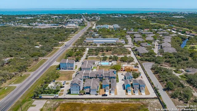 an aerial view of residential houses with outdoor space