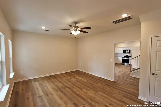 wooden floor in an empty room with a window