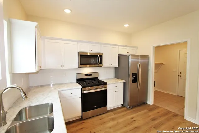 a kitchen with stainless steel appliances a refrigerator stove and sink