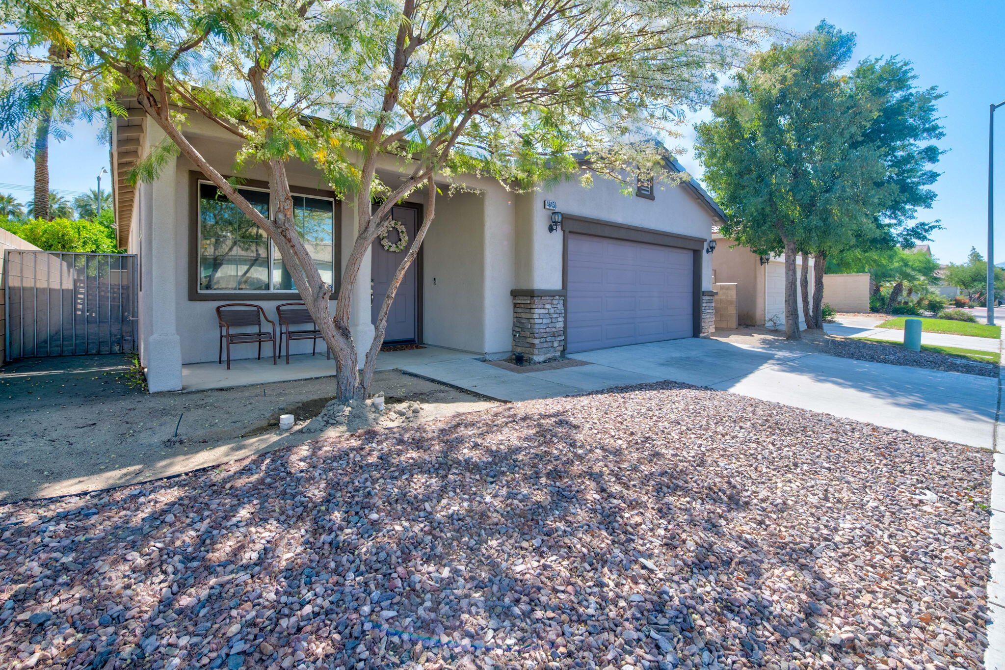 46450 Calle Raphael Indio, CA 92201 - Photo 2 of 29 a front view of a house with a yard and garage