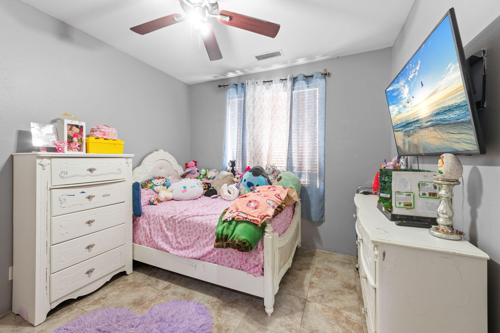 46450 Calle Raphael Indio, CA 92201 - Photo 21 of 29 a bedroom with a bed and a flat tv screen on dresser