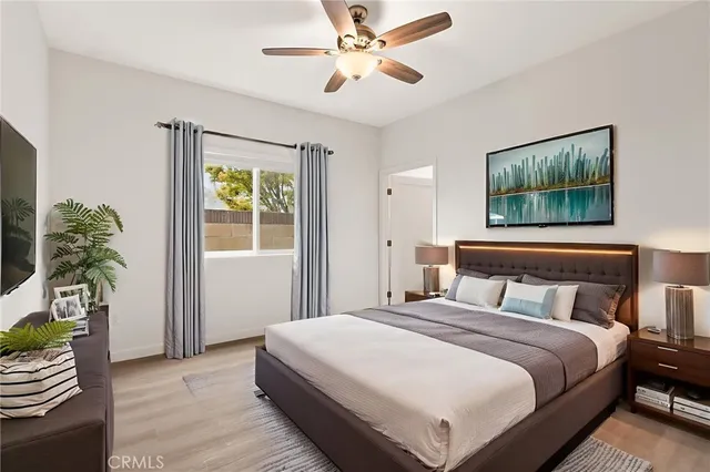 a bedroom with a bed and a chandelier