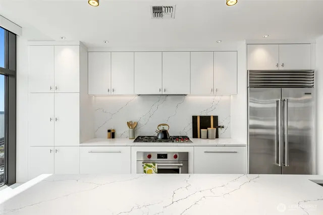 a kitchen with refrigerator and cabinets