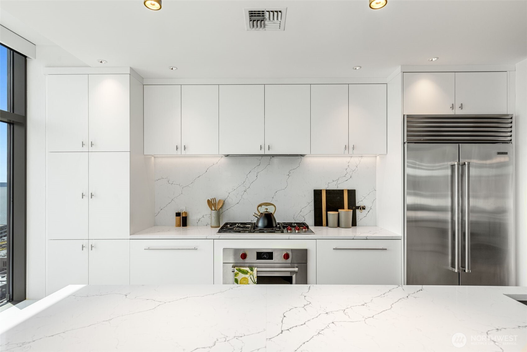 2033 2nd Avenue, Unit 1111 Seattle, WA 98121 - Photo 11 of 40 a kitchen with refrigerator and cabinets