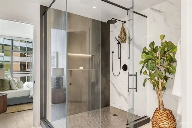 a bathroom with a shower and a glass door shower