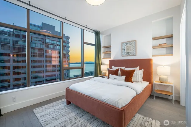 a bedroom with a large bed and a large window