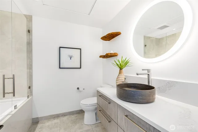 a bathroom with a sink a toilet and a mirror