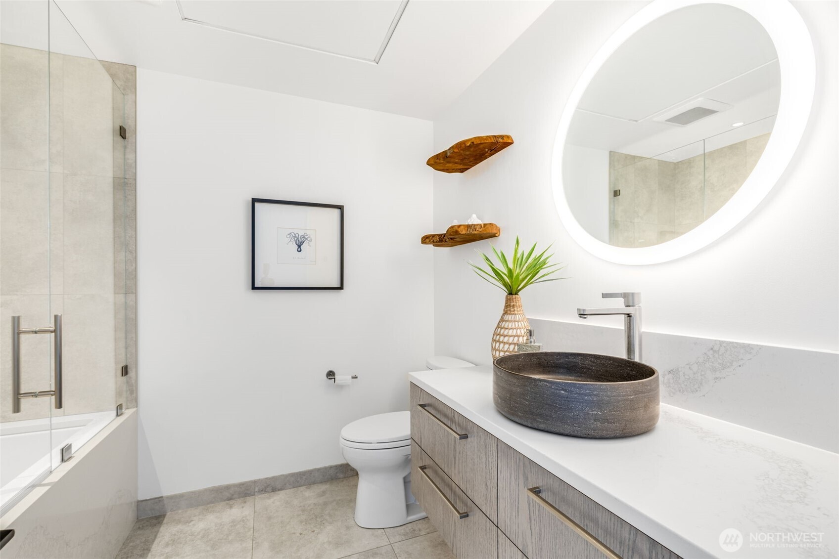 2033 2nd Avenue, Unit 1111 Seattle, WA 98121 - Photo 24 of 40 a bathroom with a sink a toilet and a mirror