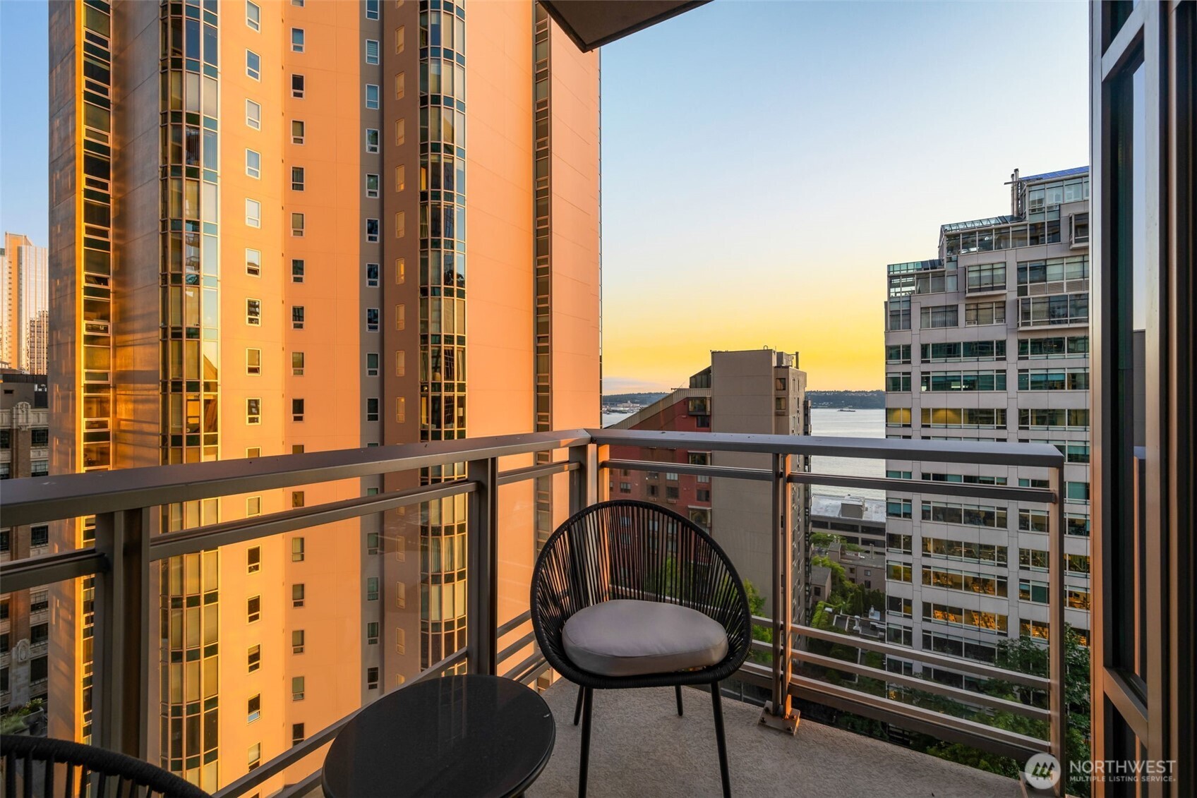 2033 2nd Avenue, Unit 1111 Seattle, WA 98121 - Photo 27 of 40 a view of balcony with a couple of chairs and a large tree